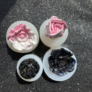 Detail view of 3D floral silicone molds with finished resin flower art pieces