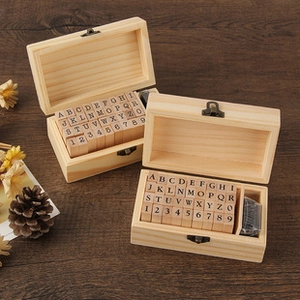 Detail of 36pcs wooden stamp set with letters and numbers in a vintage storage box