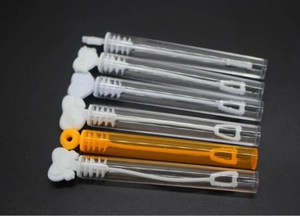 Close-up of heart-shaped bubble wands in white and orange for wedding party decor