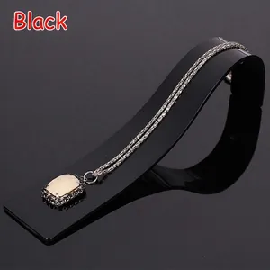 Elegant rectangular marble pendant necklace on a black acrylic display stand holder