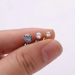 Detailed comparison showing 3-prong zircon stud earrings size scale held by fingers