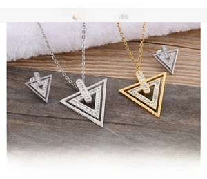 Detailed view of geometric triangle jewelry set with cubic zirconia in gold and silver