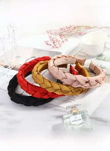 Detail showing braided fabric headband textures in pink, yellow, red, and black, 2.5cm width