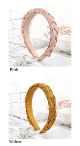 Detail of pink and yellow twisted braided fabric headbands in a stylish display