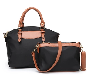 Detailed set of two black oxford cloth tote bags with brown handles and gold hardware