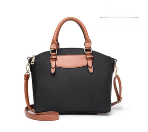 Front view of black Oxford cloth tote bag with brown handles and gold hardware details