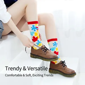 Off-white crew socks with colorful maple leaf patterns paired with brown leather shoes