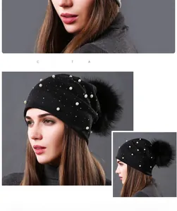 Detail of black knit beanie with pearls, rhinestones, and fluffy fur pom-pom