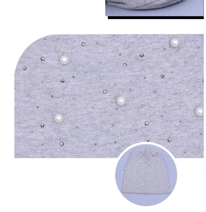 Macro detail of grey cotton beanie featuring white pearls and sparkling rhinestones