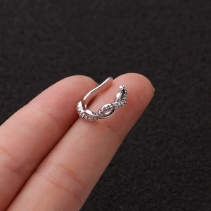 Detailed view of silver twisted ear cuff with sparkling pavé cubic zirconia crystals