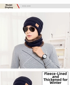 Close-up of navy blue knitted hat and neck warmer set with warm brown fleece lining