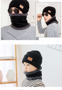 Detail of black winter knit hat with thick grey fleece lining for warmth and comfort