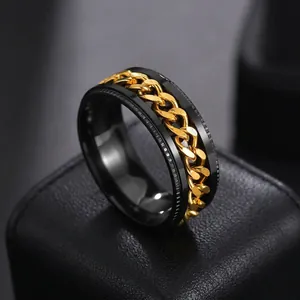 Detail of black matte rotating ring with golden cuban chain inlay for men