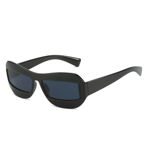 Cat eye sunglasses with thick black frame and dark lenses in hip hop street style
