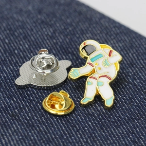Detail of creative astronaut enamel pin with gold plating and butterfly clutches