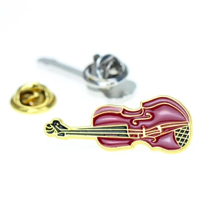 Detail of red cello enamel brooch with gold base and two metal butterfly clutch backings