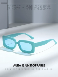 Detail view of turquoise rectangular sunglasses with a thick frame in a minimalist style
