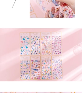 Close-up of 8 sheets of gold foil unicorn and galaxy stickers with pink dreamy aesthetic