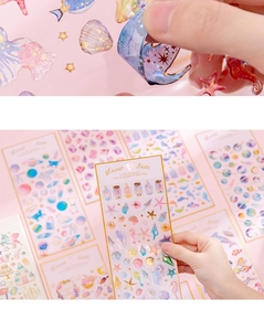 Macro detail of unicorn crystal epoxy stickers with gold stamping and ocean motifs