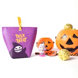 Close-up of Halloween treat bags, pumpkin candy jars and chocolate gift packaging