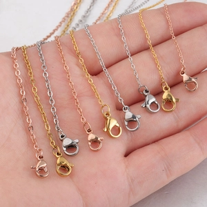 Multi-color lobster clasp chains in rose gold, gold, and silver on a hand