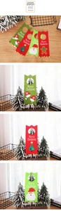Detail of felt Christmas door hangers featuring Santa Claus and bells for festive decor