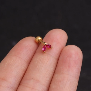 Detail of gold screw-back stud earrings with marquise-cut red zircon leaf pattern