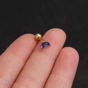 Elegant gold stainless steel marquise blue zircon stud earring held between fingers