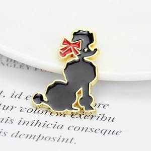 Golden and black enamel poodle brooch with red bow on a decorative white plate