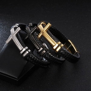 Mens woven leather bracelets with silver black and gold cross charms in diagonal view