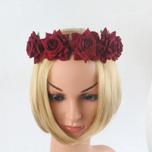 Detailed close-up of dark red artificial rose floral headband for festive party hair styling
