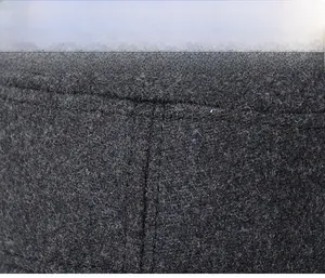Detail of dark gray wool fabric with premium double stitching on the military cap