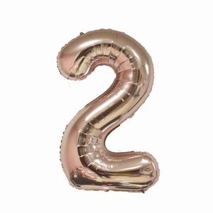Detailed view of large rose gold 40-inch foil balloon in the shape of number 2