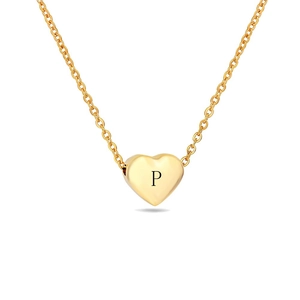 Macro detail of golden heart pendant featuring a laser-engraved letter P on polished metal