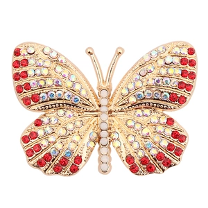 Golden butterfly jewelry accessory with red and iridescent rhinestones and white pearls