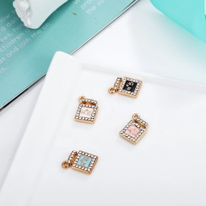 Detail of N°5 perfume bottle charms in four colors with sparkling rhinestones for DIY
