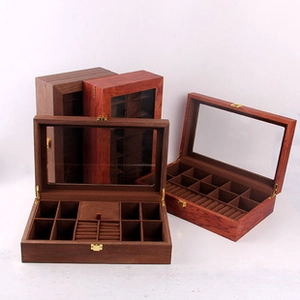 Detail of wooden jewelry box featuring velvet ring slots and metal hinge hardware