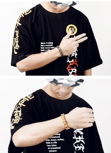 Detail of masculine titanium steel chain bracelets in gold and black silver on wrist