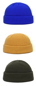 Detailed knit texture of skull caps in blue, ginger yellow, and dark green colors