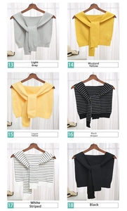 Detail view of knitted shawls in six colors including solid tones and classic stripes