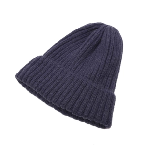 Detailed close-up of dark blue ribbed knit texture on a minimalist baby beanie