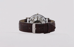 Macro view of skeleton back case showing internal mechanical movement of leather strap watch