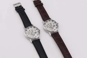 Detail of hollow movement men's quartz watches with leather straps in black and brown
