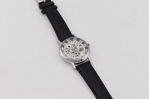 Detailed close-up of hollow dial mechanism with black alligator strap and Roman numerals