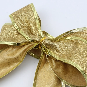 Close-up of a 15cm gold glitter Christmas bow with detailed texture for tree decoration