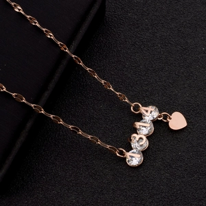 Macro shot of rose gold necklace featuring zircon-inlaid 1314 digits and heart charm