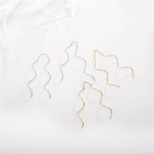Detail of S-shaped wave tassel threader earrings in silver, gold and rose gold finishes