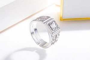 Macro view of men's silver ring featuring a large square zircon and geometric patterns