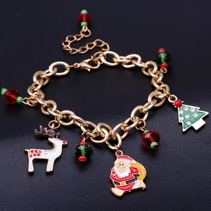 Christmas charm bracelet with Santa Claus, elk and tree charms on golden chain links