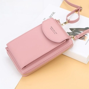 Detail of a pink leather crossbody phone wallet with high-quality zipper and metal hooks